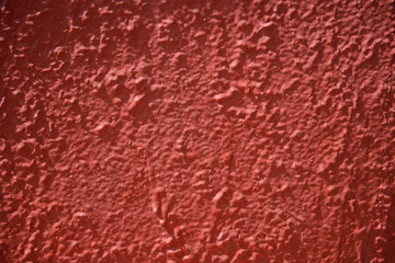 inaccurately painted red surface with stains of paint