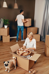 Fototapeta premium New House. Man And Woman With Boxes