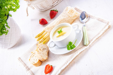 asparagus cream soup with capers and fresh baguette