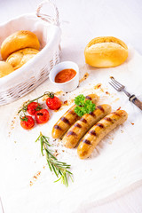 delicious bratwurst with ketchup and fresh rolls