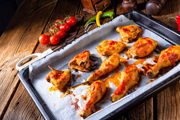 Rustic backed chicken wings,legs on baking tray