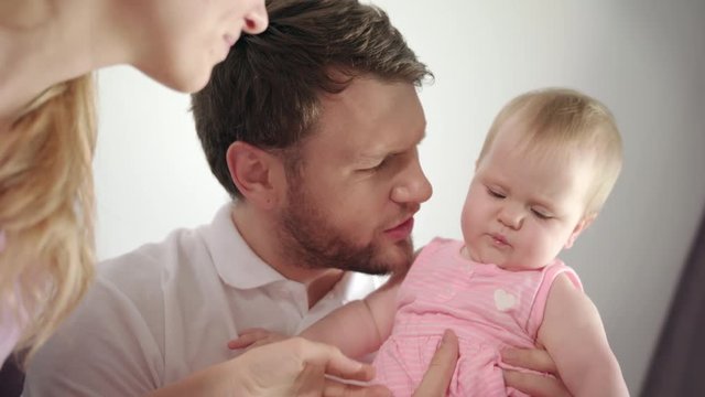 Father kissing baby girl. Dad kiss daughter infant at home. Close up of man kissing child in hands. Male tenderness. Happy family together. Portrait of father holding baby girl. Family care child