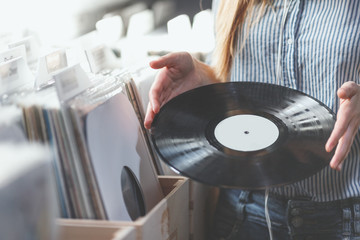 Young woman with music records indoors