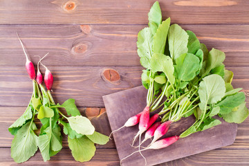 Fresh ripe washed radish on a cutting board on a wooden table. Top view