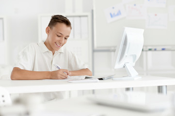 Obraz na płótnie Canvas Teenage boy with laptop