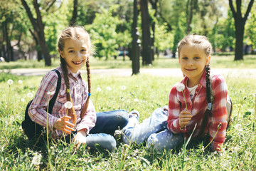 little girlfriends with dandelions