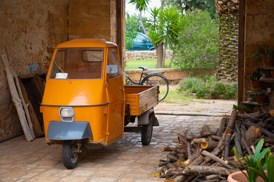 Orange three wheels car used for transporting
