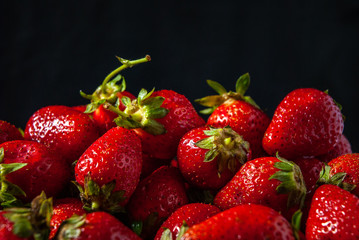 ripe strawberries on a black background
