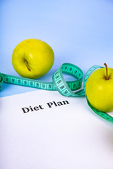 Apples, diet plan,dumbbells and measuring tape