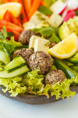 Vegan buddha bowl salad with vegetables, tofu, black beans meatballs and avocado. Healthy vegan food concept.
