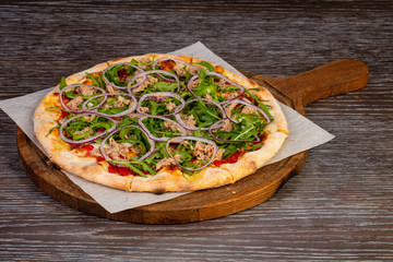 Pizza with arugula and tuna