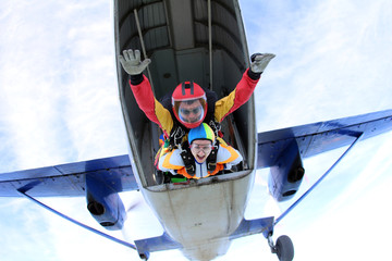 Skydiving. Man and woman are doing tandem jump.