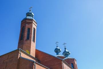Dome of Orthodox Christian Church of red brick in summer sunny day
