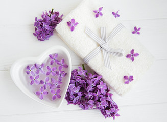 Fototapeta na wymiar Spa towel and lilac flowers
