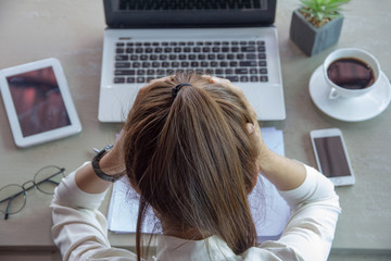  businesswoman feeling stress from work in the office.