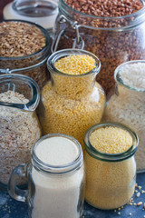 Rice (white and black), millet, oatmeal (ground and in grains), couscous, buckwheat, semolina in teklyannoy dishes, selective focus