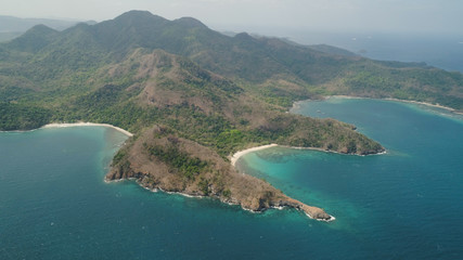 Fototapeta na wymiar Aerial view of seashore with beach, lagoons and coral reefs. Philippines, Luzon. Coast ocean with tropical beach, turquoise water. Tropical landscape in Asia.