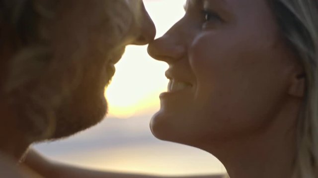 Close up of affectionate couple looking each other in eyes and smiling on date