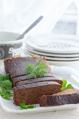 Delicate pate-casserole from chicken liver on a white plate, selective focus