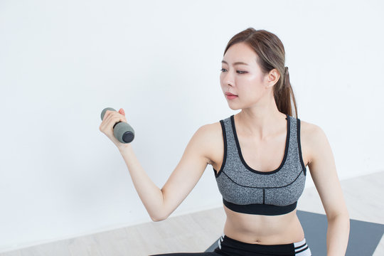 Young Fitness Asian girl lifting dumbbell, workout in bedroom, fitness, training and lifestyle concept