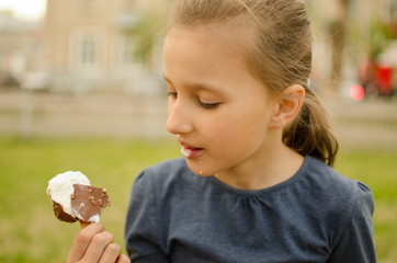 girl eating ice cream on a sunny day