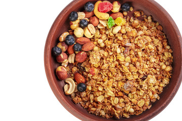 Bowl of homemade granola with fruit pieces isolated on white