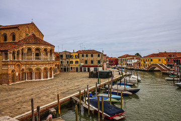 Murano island canal boats, Venice, Italy. Santa Maria and San Donato Cathedral.