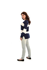 full length portrait of girl wearing striped blue and white jumper and jeans. standing pose  facing away from the camera, on white studio background