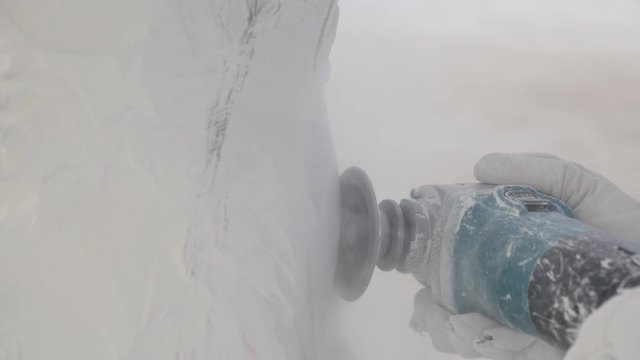 Close up of a sander grinder smoothing out plaster