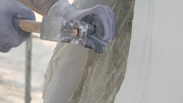 Slow motion hands chiseling away at a statue