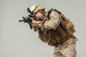 Soldier in camouflage holding rifle