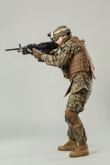 Soldier in camouflage holding rifle