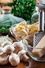 Ingredients ready for prepare tagliatelle pasta with champignon