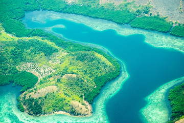 Aerial view of Busuanga island. Tropical lagoon with turquoise water, coral reef and white sand.