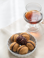Bowl of chocolate sweets accompanied with a glass of liquor
