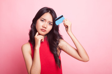 Young Asian woman think with a blank card.