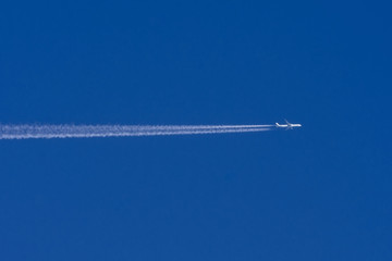 White aircraft big two engines aviation airport contrail clouds.