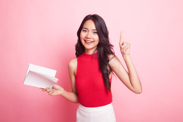 Young Asian woman with a book have an idea.