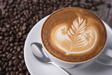 latte or Cappuccino with frothy foam, coffee cup top view on table in cafe.