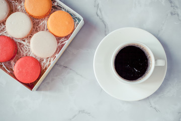 a cup of coffee with sweets on a gray marble background. Copy space. Selective focus.