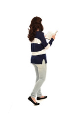 full length portrait of girl wearing striped blue and white jumper and jeans and holding a book. standing pose on white studio background