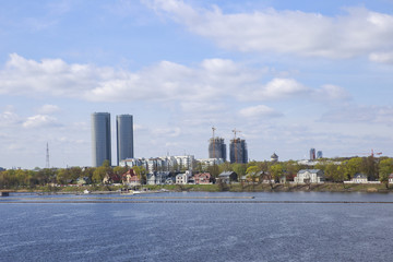 Obraz premium blue sea, city and sky with clouds