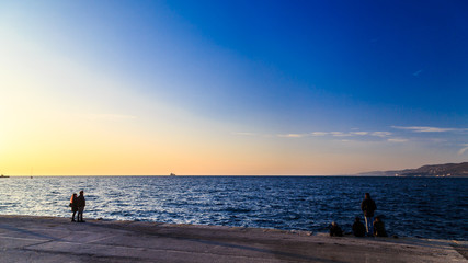 Fototapeta premium Colorful sunset in front of the city of Trieste