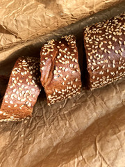 Bread with sesame seeds on a background of brown paper.