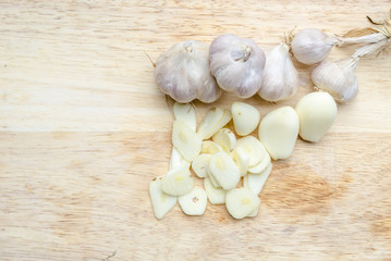garlic on Wooden cutting board isolated on white background