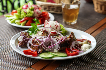 Barbecue with vegetables and sauce