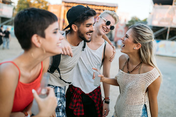 Happy friends having fun at music festival