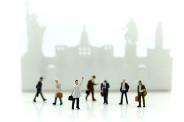 Obraz premium Miniature people : businessman waiting for a taxi in front of the airport,business meeting concept.