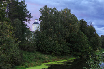 The Church on the river Bank surrounded by trees