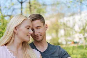 Naklejka premium Loving young couple enjoying a tender moment